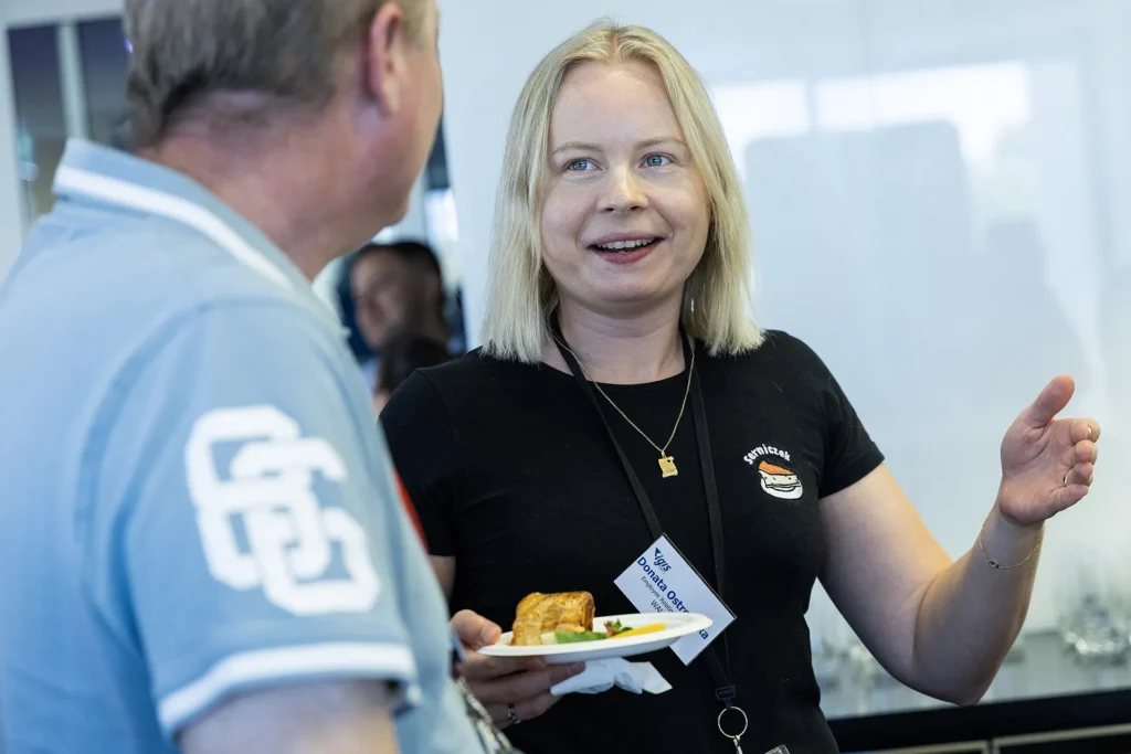 Lady laughing holding plate of food