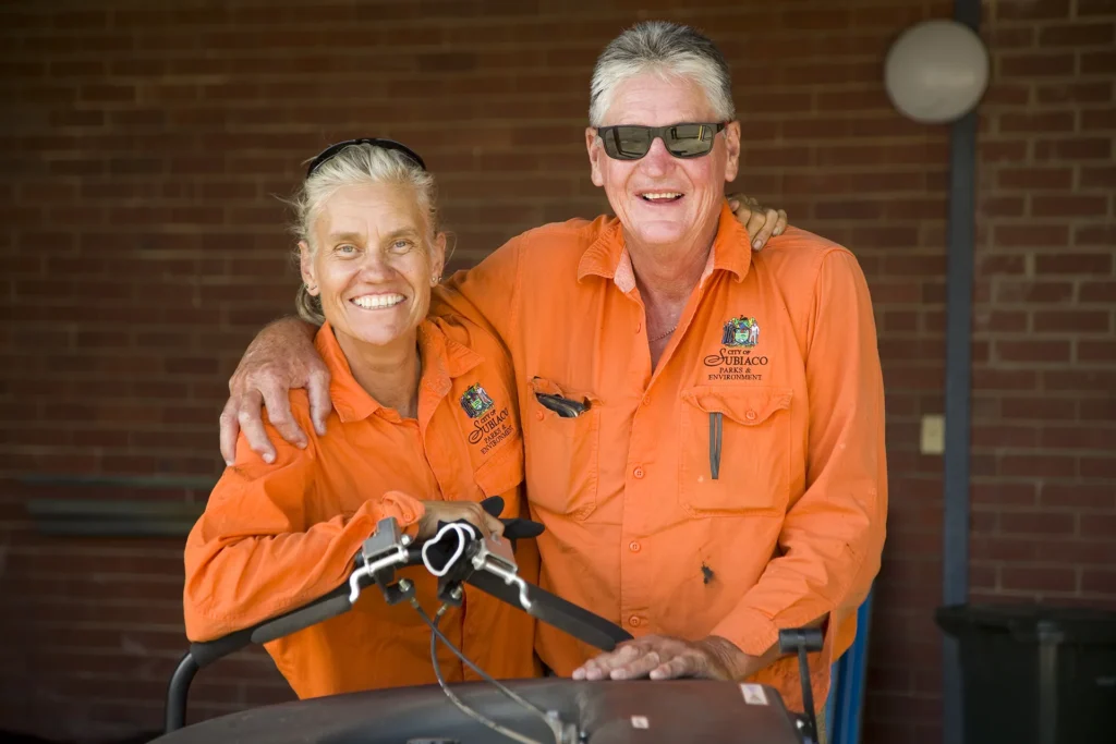 Man and woman in high vis smiling